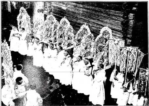 Youths carrying statues on their shoulders while waiting to take part in the procession of C. D. at Visperterminen. Valais (Switzerland).