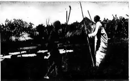 a) SOME MANIFESTATIONS OF PRIMITIVE ECONOMY. Stick fighting. The stick held in the right hand is used to strike; the one in the left hand is used to parry the opponent's blows - Acioli population of Uganda (British East Africa). b) SOME MANIFESTATIONS OF PRIMITIVE ECONOMY. How the Acioli of Uganda (