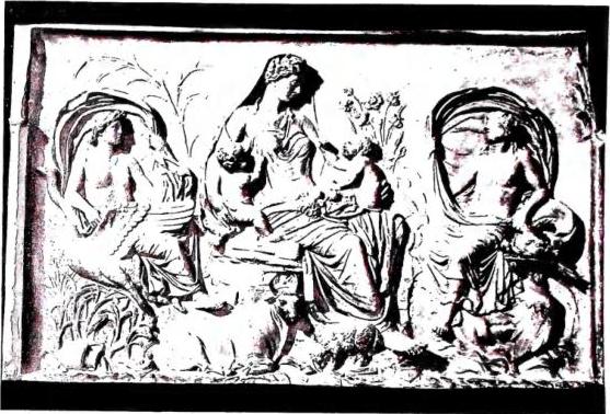 Above: PERSONIFICATION OF 'TELLUS' between Air and Water. Detail of the reliefs of the Ara Pacis (9 BC) - Rome. Below: PERSONIFICATION OF 'EARTH'. Miniature of the Exultet I (ca. 1000) - Bari, Cathedral.
